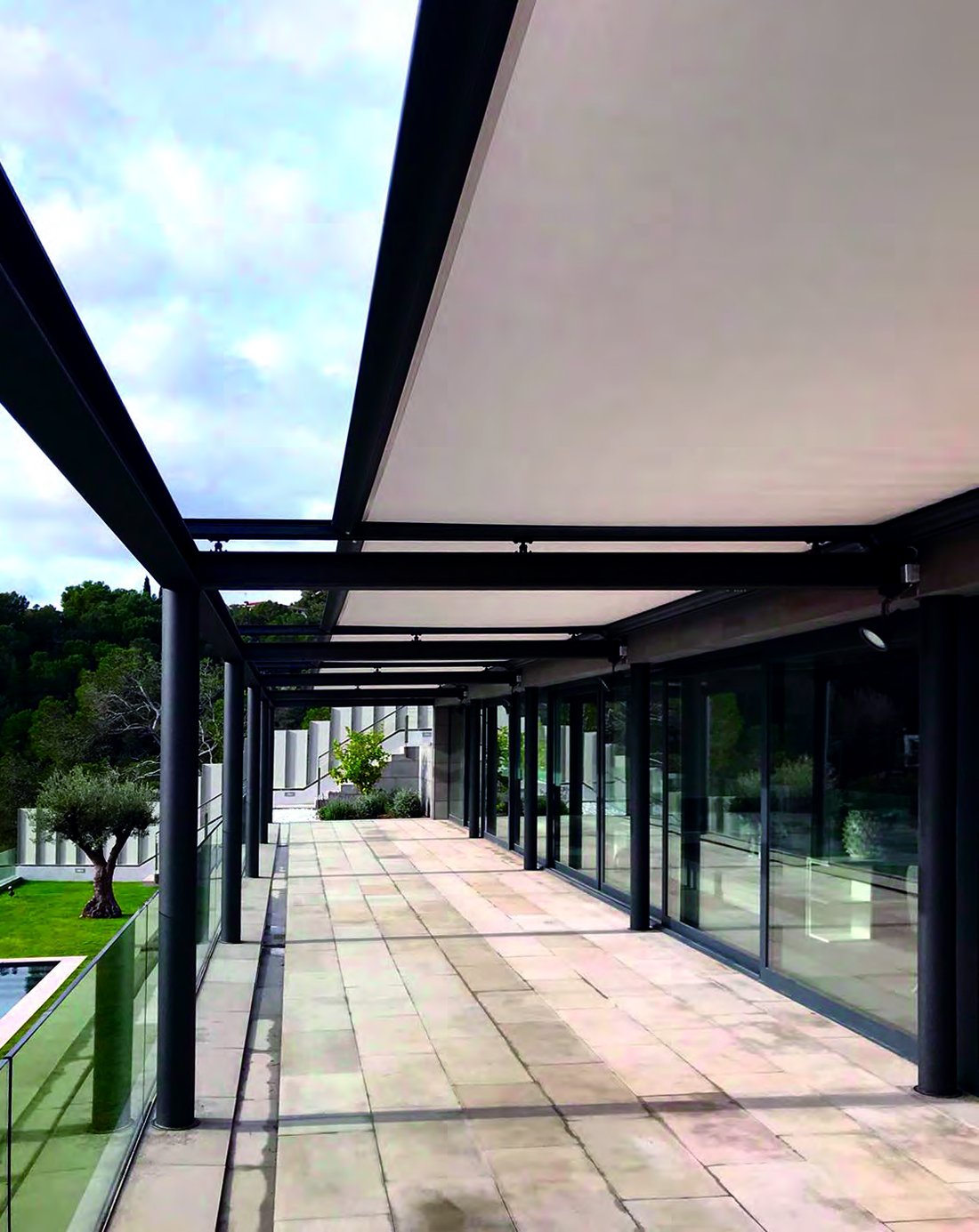 Retractable awning shading a poolside terrace